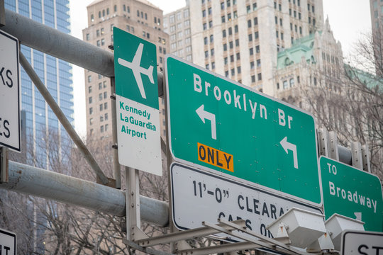 Brooklyn Bridge And Airports Street Signs In New York City