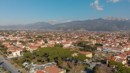 Fototapeta na wymiar Aerial panoramic view of Forte dei Marmi skyline on a sunny winter morning, drone perspective