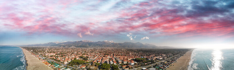 Aerial panoramic view of Forte dei Marmi skyline on a sunny winter morning, drone perspective - obrazy, fototapety, plakaty