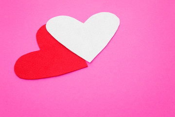 Obraz premium Two felt form of hearts on a pink background
