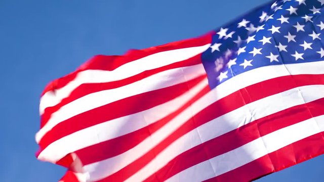 4k Slow Motion American Flag Blowing in Wind Blue Sky Afternoon