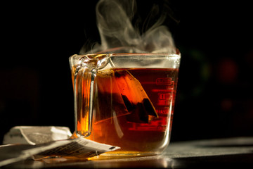 Tea bags brew in a measuring cup