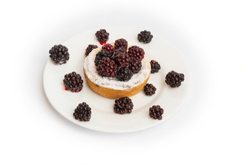 Sweet blackberry cake on white plate