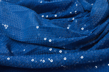 blue cloth with metal round sequins, lined with pleat. Sequined stripped fabric with for wallpapers and manufacture, store and fashion catalogue.