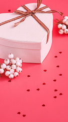 St. Valentine day background. Gift box with gold ribbon and lights on a pink background. Holiday background.