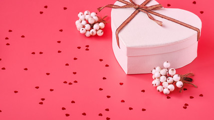 St. Valentine day background. Gift box with gold ribbon and lights on a pink background. Holiday background.