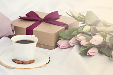 Bouquet of flowers - tulips, gift and coffee.