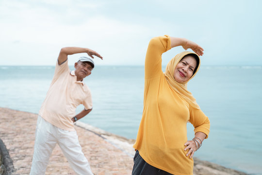 couple asian muslim stretching and exercising together