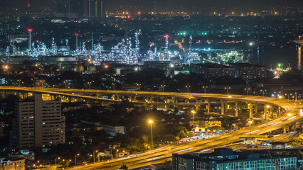 Bangkok city, Thailand, showing traffic on motor way and oil refinery at night