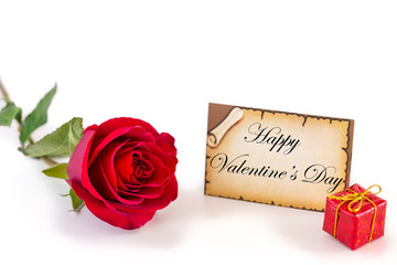 Greeting card with single red rose and gift box on pure white background