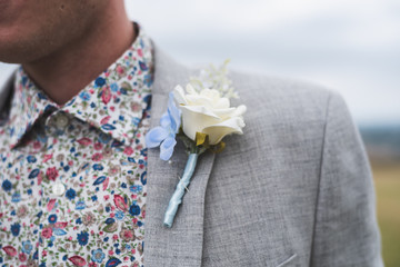 A grooms buttonhole white rose corsage 
