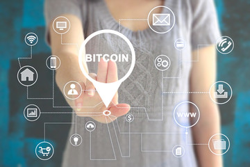 Businessman presses button bitcoin web currency on virtual electronic user interface.