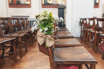 Decorative wedding chairs at a church before the ceremony 