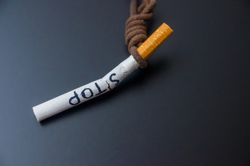 hanging cigarete on black background. kill yourself. Quitting smoking concept. world no tobacco day