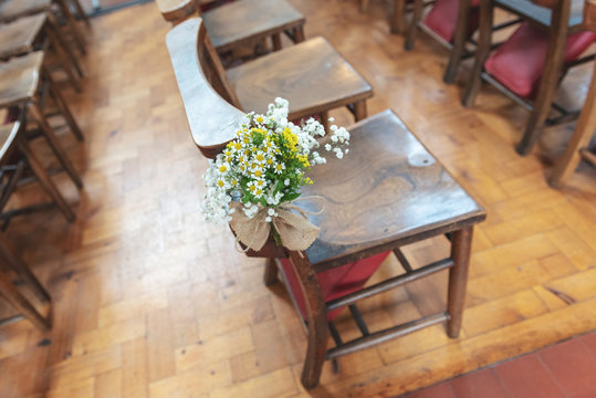 Decorative wedding chairs at a church before the ceremony 