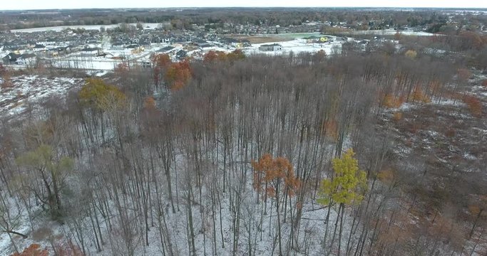 Flying Over Winter Trees Towards New Real Estate Housing Development In Winter