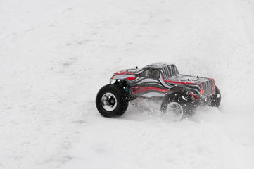 Radio-controlled car starts on a snowy road. © gangster9686