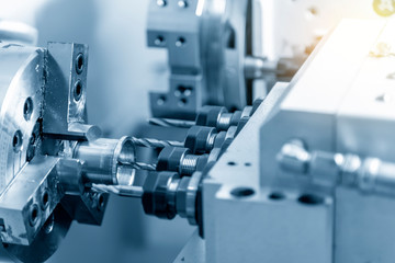 The CNC lathe or turning machine cutting the drilling the cylindrical part.Hi-technology manufacturing process.