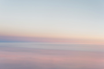 Sky in the pink and blue colors from aiplane window. effect of  pastel colored of sunset clouds