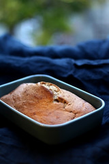 Homemade baked banana bread on a dark blue tablecloth. Selective focus.