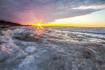 Scenic Winter Sunrise Landscape. Scenic sunrise reflection over the icy Great Lakes horizon on the coast of Lake Huron.