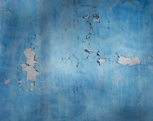 Background blue wall with falling off paint.