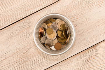 Different coins in a metal basket. The view from the top. The concept of poverty. The concept of savings.