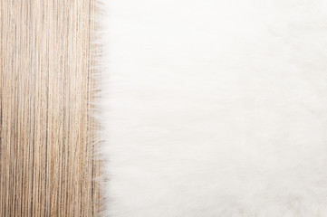 fur carpet background on light wooden floor. top view, copy space