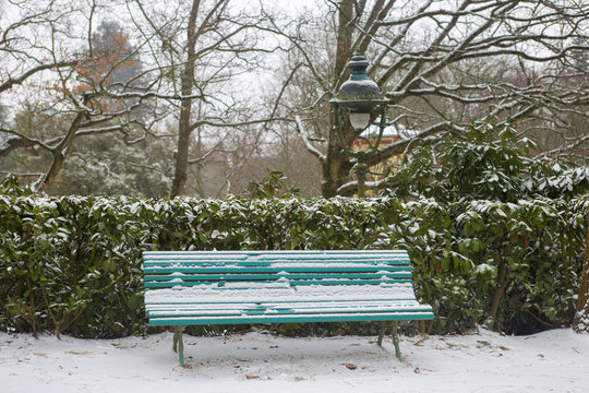Garden park in Rennes to Thabor, bench with snow, France