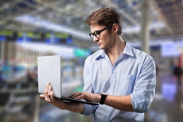 Male hands holding and using laptop