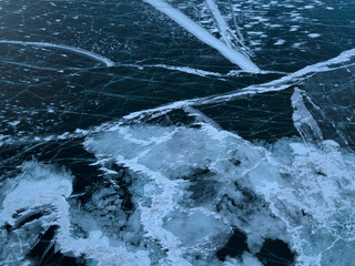 View of the frozen Lake Baikal in winter from drone. Ice cracks on lake. Abraham Lake, Lake...