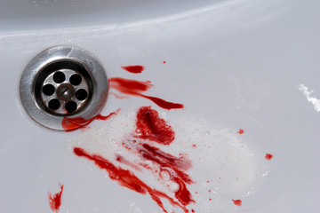 Flowing blood in the sink. Murder concept background