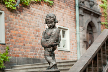 Sculpture of boy with catching fish in courtyard of Stockholm Stadshuset, built in 1923. Examples...