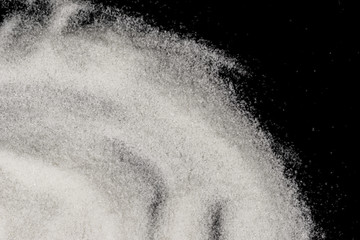 Scattered sugar on a black background