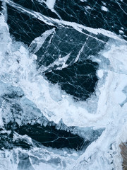 View of the frozen Lake Baikal in winter from drone. Ice cracks on lake. Abraham Lake, Lake...
