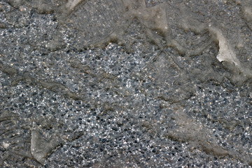 Melting snow asphalt slush water flow puddle dirty street sidewalk