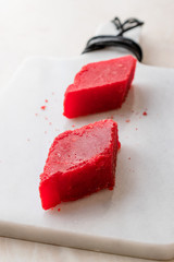 Crystallized Turkish Delight Red Sugar. Crystal Confectionery Nobet Sekeri on White Marble Surface.