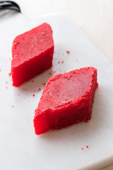 Crystallized Turkish Delight Red Sugar. Crystal Confectionery Nobet Sekeri on White Marble Surface.