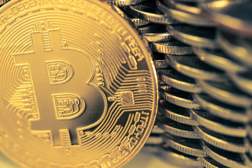 Bitcoinon the background of the wall of coins. Economy trends virtual digital currency concept.