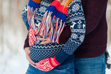 Beautiful pregnant woman in winter forest