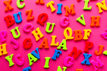 colored letters on pink background