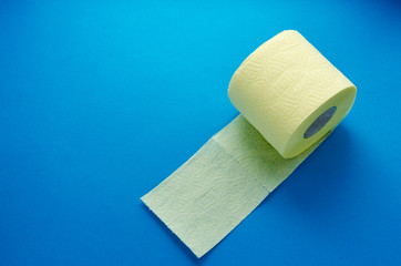 yellow toilet paper roll on blue backgroung