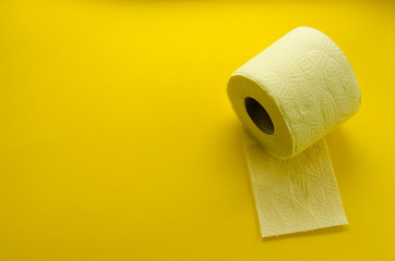 yellow toilet paper roll on yellow backgroung