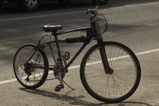  black bicycle on sunny street.