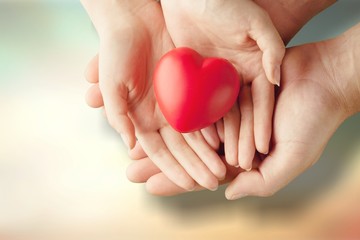 Fototapeta premium Man and woman holding red heart
