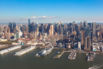 Fototapeta na wymiar New York Midtown Manhattan in NYC NY in USA. Aerial helicopter view. Pier 84 at Hudson River Park and circle line Sightseeing Cruises