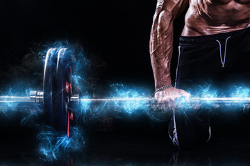 Closeup photo of strong muscular bodybuilder athletic man pumping up muscles with barbell on black background. Workout energy bodybuilding concept. Copy space for sport nutrition ads.