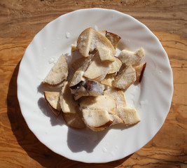 Chopped frozen  Boletus Edulis mushrooms on a white plate from the wood