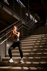 Young fitness woman doing exercises outdoor