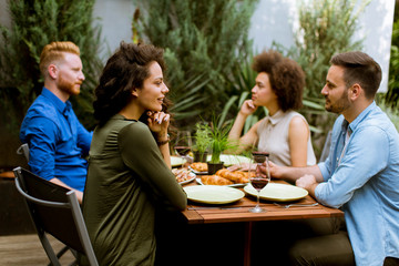 Cheerful young people have lunch in the courtyard and have a fun